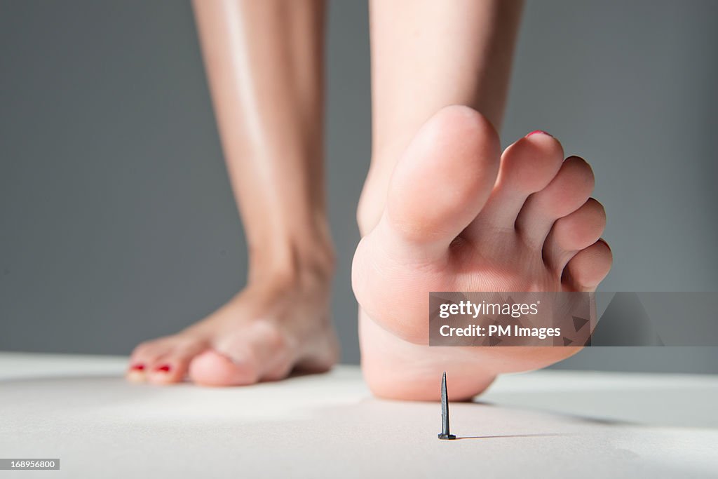 Foot about to step on nail