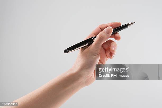 hand holding pen - holding pen in hand stock pictures, royalty-free photos & images