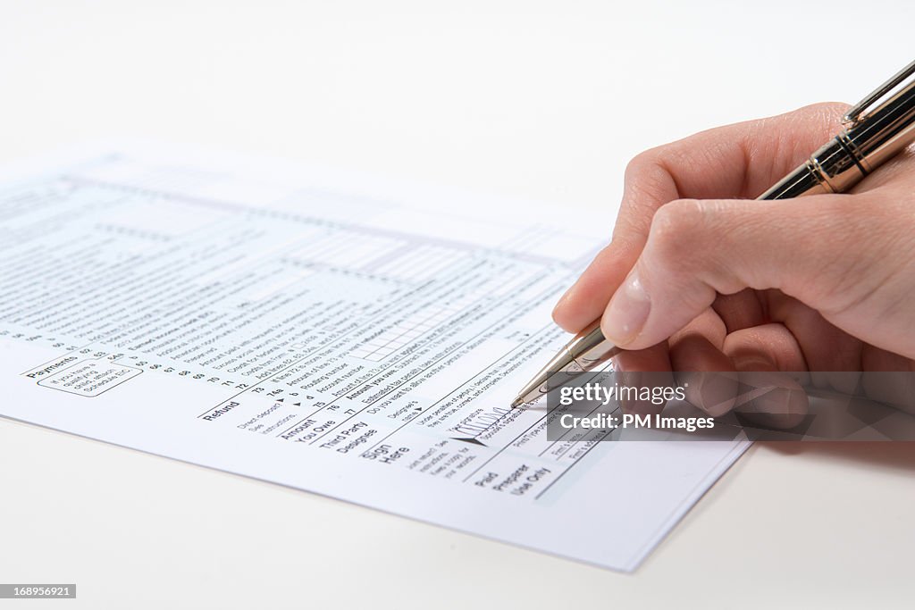 Signing Tax Form High-Res Stock Photo - Getty Images