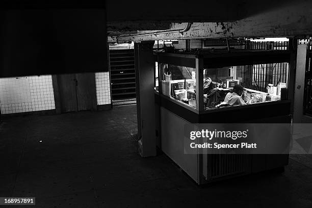 Subway station attendant sits in a booth of the Kingston-Throop Ave. Station, where MTA worker Harry Kaufman was killed November 26 after being...