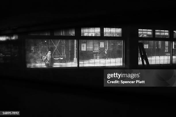 People walk along a street near where two people were murdered in 1989 in Bedford-Stuyvesant on May 16, 2013 in Brooklyn borough of New York City....