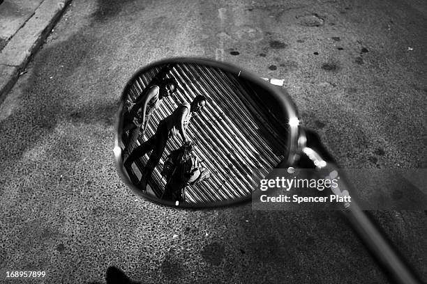 People walk by the address where Nathaniel Cash was murdered in 1991 in Bedford-Stuyvesant on May 16, 2013 in Brooklyn borough of New York City....