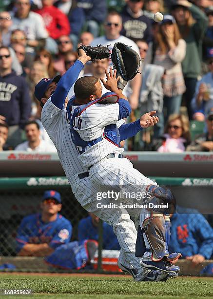 Welington Castillo and Anthony Rizzo of the Chicago Cubs collide trying to catch a foul ball against the New York Mets at Wrigley Field on May 17,...