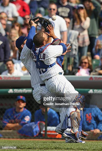 Welington Castillo and Anthony Rizzo of the Chicago Cubs collide trying to catch a foul ball against the New York Mets at Wrigley Field on May 17,...