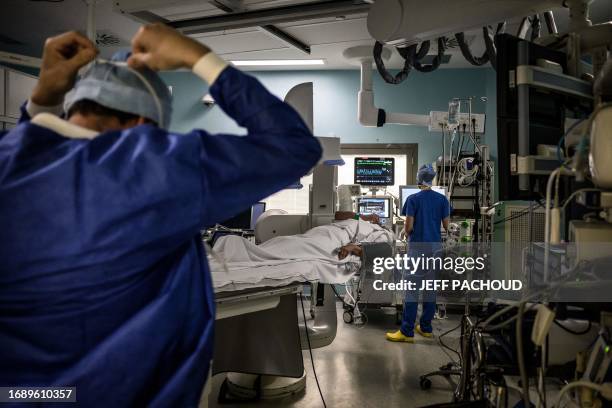 Doctors and nurses prepare the operating room before performing electroporation, a promising technique against artery fibrillation, on a patient...