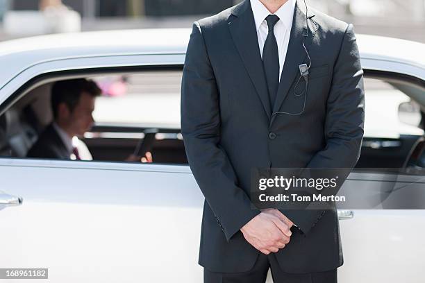 bodyguard protecting politician in backseat of car - protection stock pictures, royalty-free photos & images