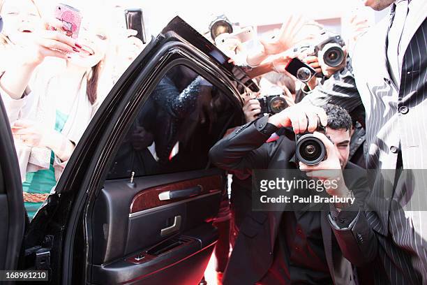 paparazzi taking pictures of celebrity in car - red carpet paparazzi stock pictures, royalty-free photos & images