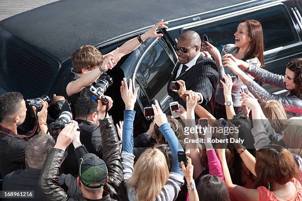 celebrity emerging from limo towards paparazzi - groupie stockfoto's en -beelden
