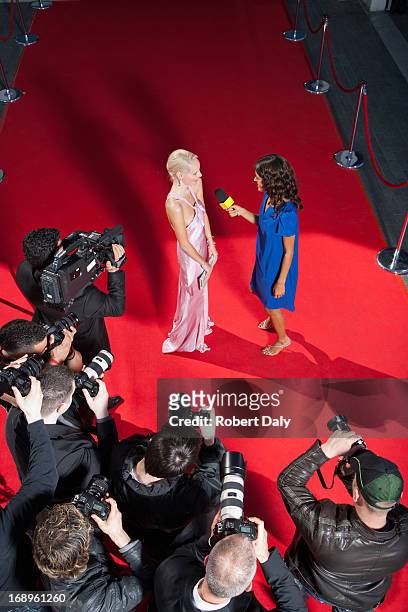 celebrity talking to reporter on red carpet - red carpet paparazzi stock pictures, royalty-free photos & images