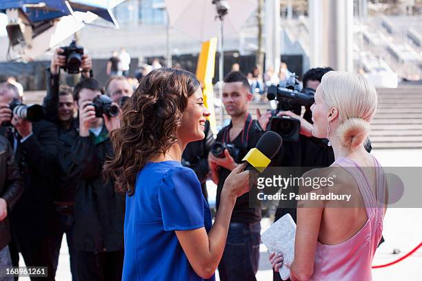 celebrity speaking to reporters on red carpet - interview event stock pictures, royalty-free photos & images