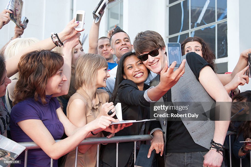 Celebrity taking pictures with fans