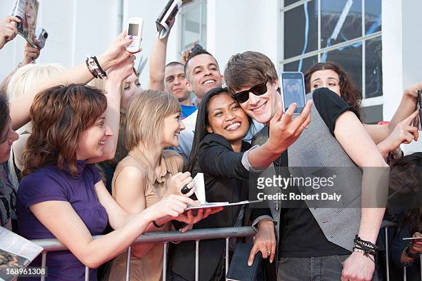 celebrity taking pictures with fans - celebrities stock pictures, royalty-free photos & images