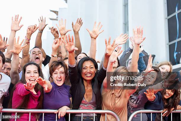 fans reaching out over barrier - groupie stock pictures, royalty-free photos & images