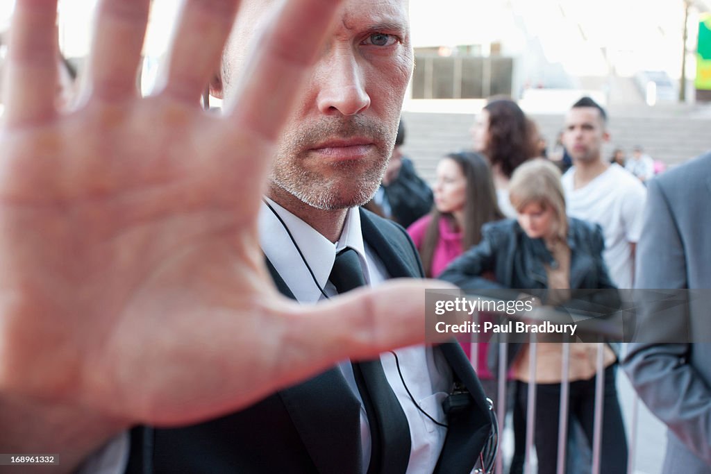 Bodyguard blocking camera