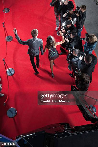 celebrities waving to paparazzi on red carpet - red carpet limo stock pictures, royalty-free photos & images