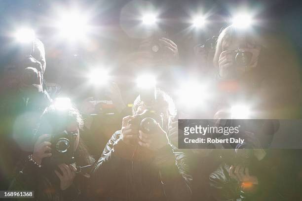 paparazzi taking pictures with flash - celebrities stock pictures, royalty-free photos & images