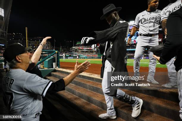 Luis Robert Jr. #88 of the Chicago White Sox celebrates with teammates with a hat and coat after hitting a three run home run against the Washington...