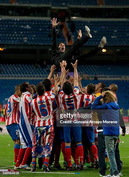 Manager Diego Pablo Simeone of Atletico de Madrid is held in the air by his teammates after winning the Copa del Rey Final match between Real Madrid...