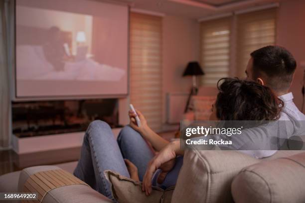 couple is watching a movie. - projection equipment stock pictures, royalty-free photos & images