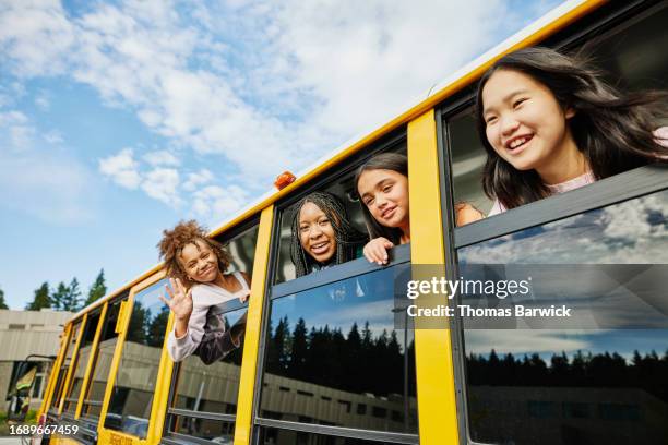 medium shot middle school girl looking out windows of school bus - open day 13 stock pictures, royalty-free photos & images
