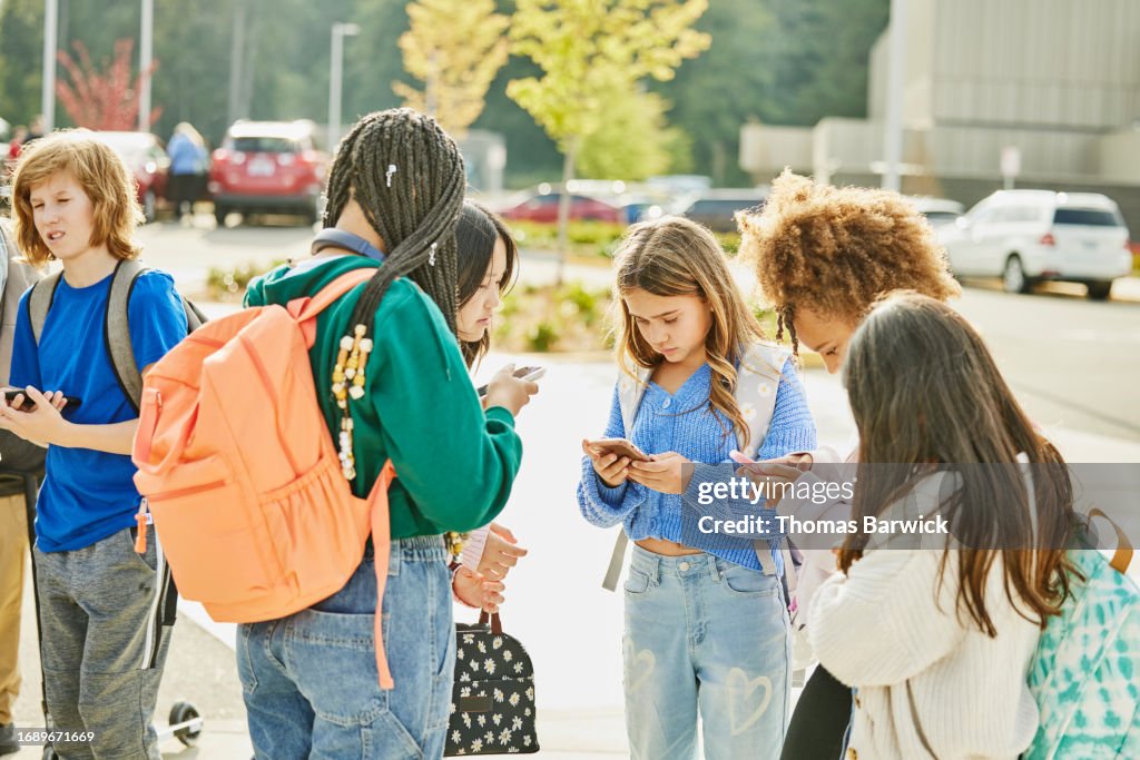 Medium wide shot middle school friends hanging out after school