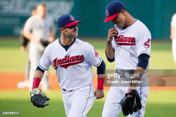 First baseman Nick Swisher talks to starting pitcher Ubaldo Jimenez of the Cleveland Indians after Jimenez caught a line drive off the bat of Kendrys...