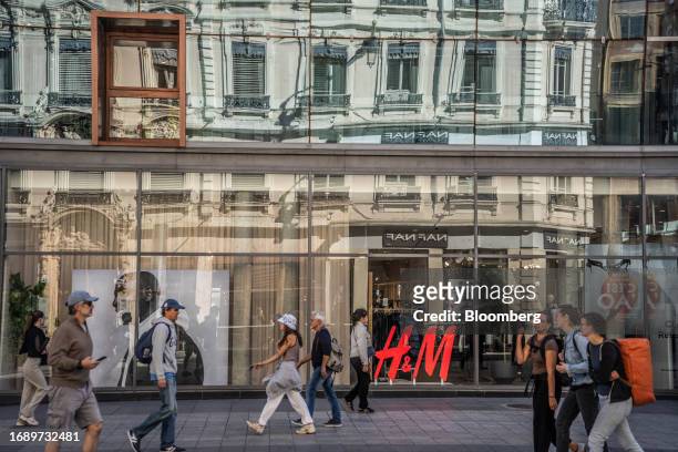 Shoppers and pedestrians pass a Hennes & Maurtiz clothing store in Lyon, France, on Monday, Sept. 25, 2023. France will announce its 2024 budget on...