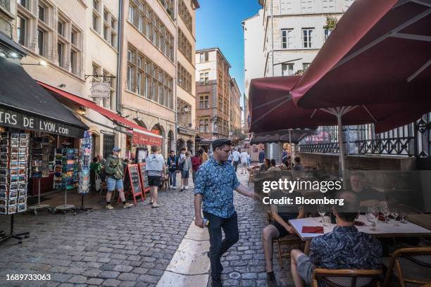 Tourists at a cafe terrace area in Lyon, France, on Monday, Sept. 25, 2023. France will announce its 2024 budget on Sept. 27. Photographer: Jose...