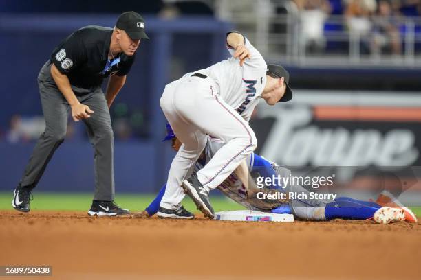 Francisco Lindor of the New York Mets steals second base as Joey Wendle of the Miami Marlins attempts to tag during the seventh inning at loanDepot...