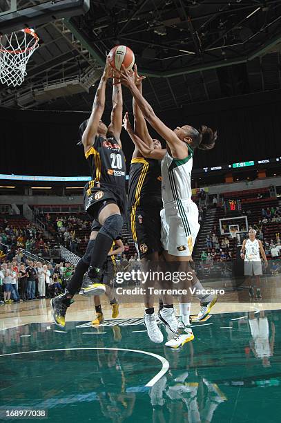 Amber Holt of the Tulsa Shock rebounds against Tina Thompson of the Seattle storm during the game on May 17, 2013 at Key Arena in Seattle,...