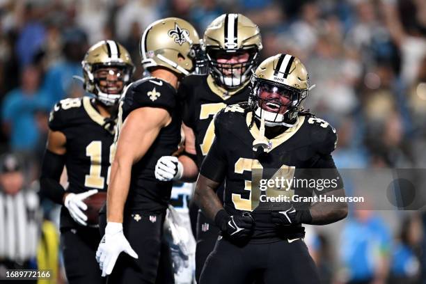 Tony Jones Jr. #34 of the New Orleans Saints celebrates with teammates after scoring a two yard touchdown against the Carolina Panthers during the...