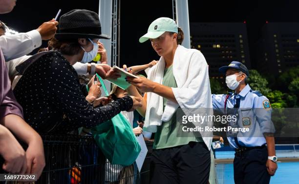 Iga Swiatek of Poland signs autographs after practice on Day 2 of the Toray Pan Pacific Open at Ariake Coliseum on September 26, 2023 in Tokyo, Japan