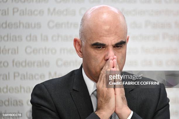 Swiss President Alain Berset gestures as he delivers a press conference to address the rates of the health insurance premiums for the upcoming year,...