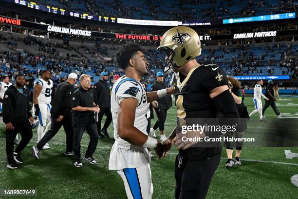 Bryce Young of the Carolina Panthers talks with Derek Carr of the New Orleans Saints after the game at Bank of America Stadium on September 18, 2023...