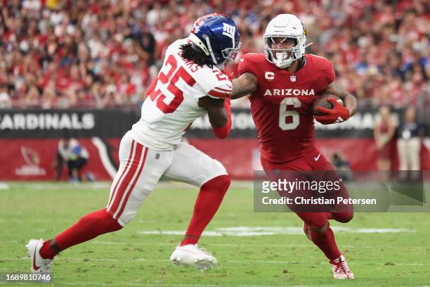 Running back James Conner of the Arizona Cardinals rushes the football against cornerback Deonte Banks of the New York Giants during the NFL game at...