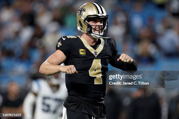 Derek Carr of the New Orleans Saints celebrates after Tony Jones Jr. #34 scored a touchdown against the Carolina Panthers during the fourth quarter...