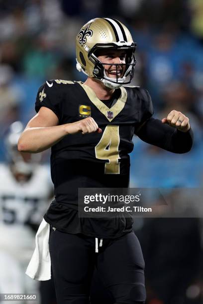 Derek Carr of the New Orleans Saints celebrates after Tony Jones Jr. #34 scored a touchdown against the Carolina Panthers during the fourth quarter...