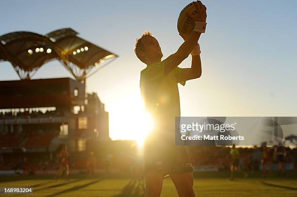 An umpire throws the ball in during the round eight AFL match between the Gold Coast Suns and the Western Bulldogs at Metricon Stadium on May 18,...