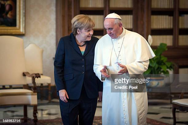Chancellor of Germany Angela Merkel chats with Pope Francis after their meeting in his private library at the Vatican on May 18, 2013 in Vatican...