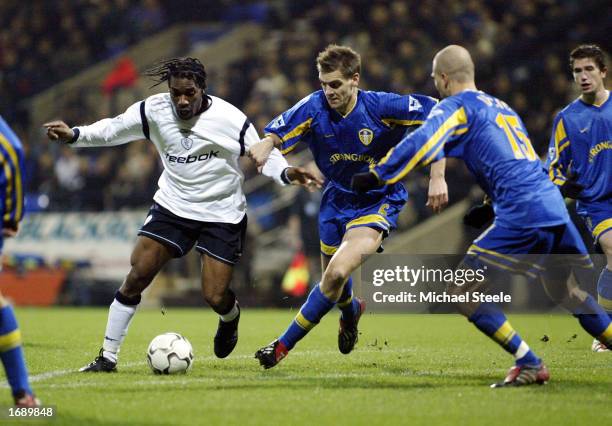 Jay Jay Okocha of Bolton holds off Jonathan Woodgate of Leeds during the FA Barclaycard Premiership game between Bolton Wanderers and Leeds United on...