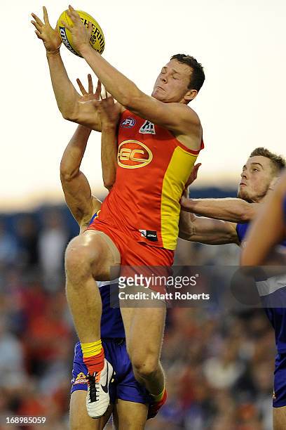 Steven Day of the Suns competes for the mark during the round eight AFL match between the Gold Coast Suns and the Western Bulldogs at Metricon...