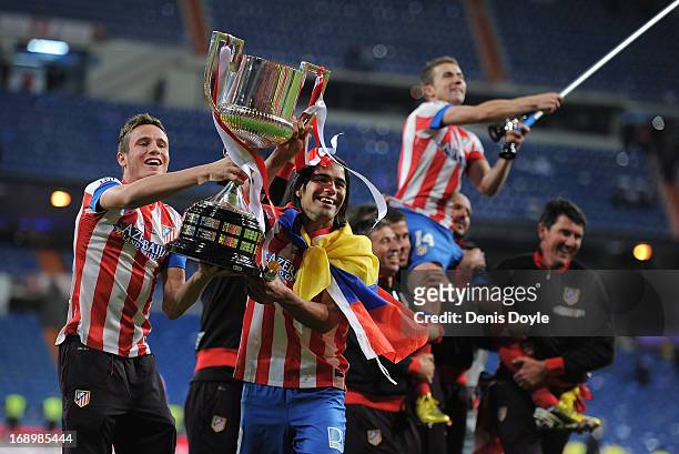 Saul Niguez and Radamel Falcao of Club Atletico de Madrid celebrate with the trophy after beating Real Madrid CF 2-1 in the Copa del Rey Final...