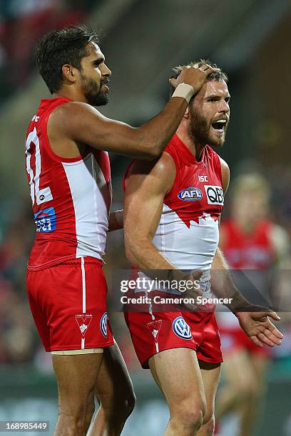 Lewis Jetta of the Swans congratulates team mate Ben McGlynn of the Swans after kicking a goal during the round eight AFL match between the Sydney...