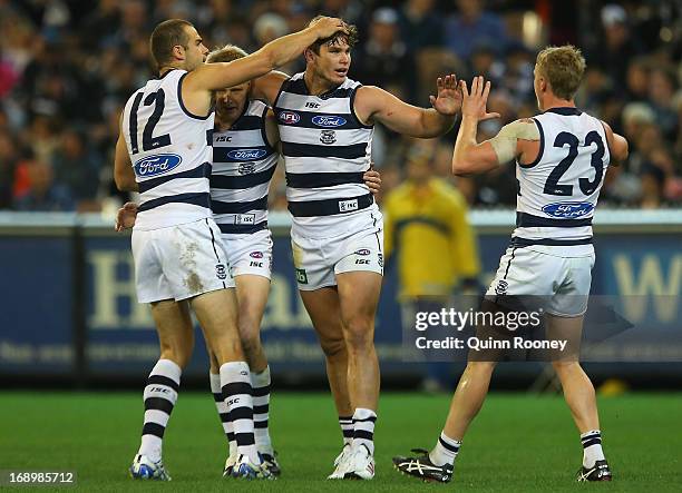 Tom Hawkins of the Cats is congratulated by team mates after kicking a goal during the round eight AFL match between the Collingwood Magpies and the...