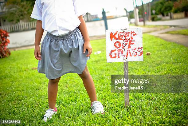 child standing on grass - keep off the grass sign stock pictures, royalty-free photos & images