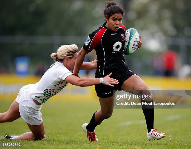 Magali Harvey of Canada is tackled by Claire Allan of England during the IRB Women's Sevens World Series match between England and Canada at the...