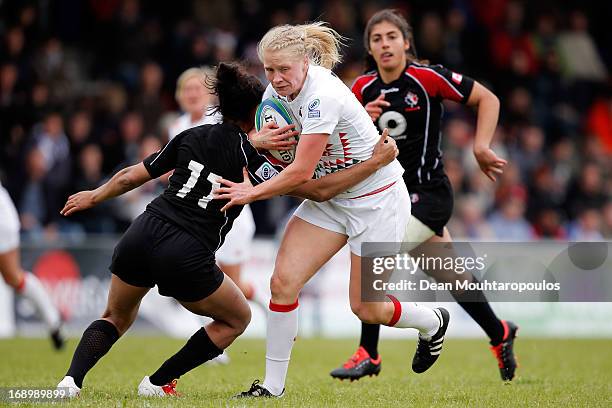 Magali Harvey of Canada tackles Alexandra Matthews of England during the IRB Women's Sevens World Series match between England and Canada at the...