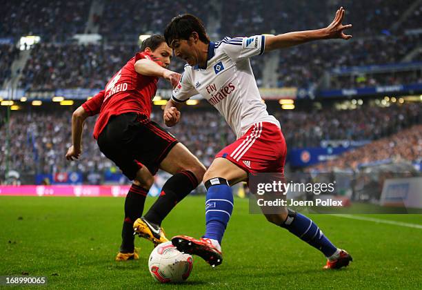 Heung Min Son of Hamburg and Philipp Wollscheid of Leverkusen compete for the ball during the Bundesliga match between Hamburger SV and Bayer 04...