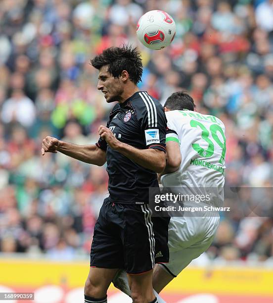 Javier Martinez of Munich and Martin Stranzl of Moenchengladbach jump for the ball during the Bundesliga match between Borussia Moenchengladbach and...