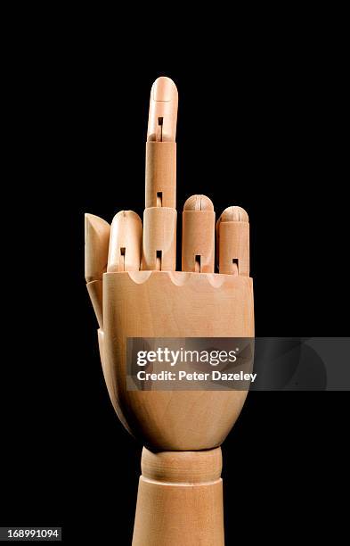 wooden hand showing rude finger - middle finger funny - fotografias e filmes do acervo